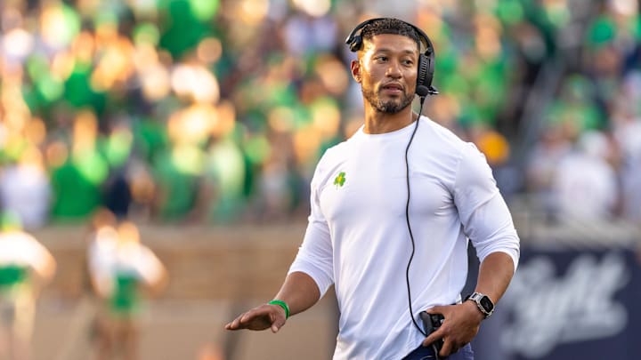 Oct 4, 2025; South Bend, Indiana, USA; Notre Dame head football coach Marcus Freeman adjusts his radio against the Boise State Broncos at Notre Dame Stadium.