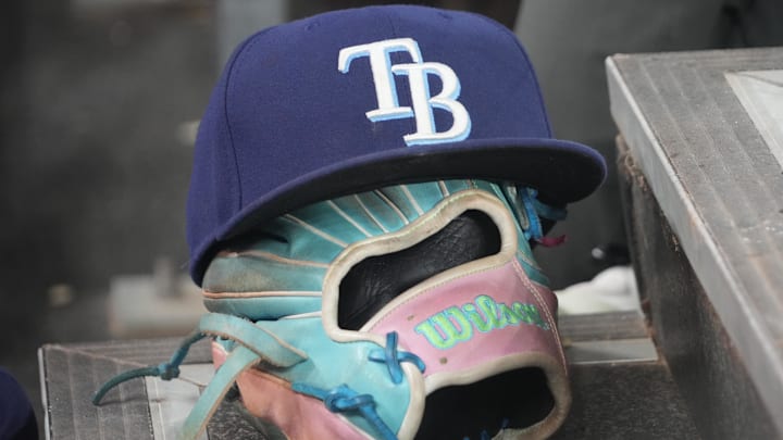 Blue Tampa Bay Rays hat on top of glove on dugout steps Blue Tampa Bay Rays hat on top of glove on dugout steps