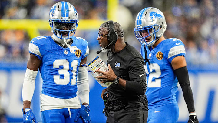 Detroit Lions Aaron Glenn talks to safety Kerby Joseph (31), left, and safety Brian Branch (32) 
