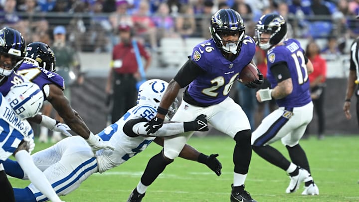Aug 7, 2025; Baltimore, Maryland, USA; Baltimore Ravens running back Rasheen Ali (26) breaks out of a tackle by Indianapolis Colts defensive end Isaiah Land (55) during the second quarter at M&T Bank Stadium. Mandatory Credit: Rafael Suanes-Imagn Images Aug 7, 2025; Baltimore, Maryland, USA; Baltimore Ravens running back Rasheen Ali (26) breaks out of a tackle by Indianapolis Colts defensive end Isaiah Land (55) during the second quarter at M&T Bank Stadium. Mandatory Credit: Rafael Suanes-Imagn Images