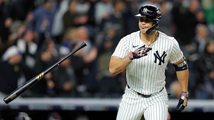 Oct 14, 2024; Bronx, New York, USA; New York Yankees designated hitter Giancarlo Stanton (27) hits a solo home run during the seventh inning against the Cleveland Guardians in game one of the ALCS for the 2024 MLB Playoffs at Yankee Stadium.