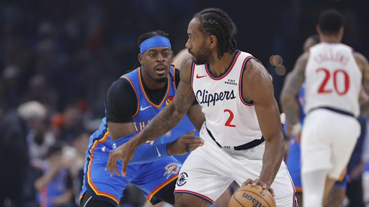 Dec 18, 2025; Oklahoma City, Oklahoma, USA; Los Angeles Clippers forward Kawhi Leonard (2) moves the ball against Oklahoma City Thunder guard Luguentz Dort (5) during the first quarter at Paycom Center. Mandatory Credit: Alonzo Adams-Imagn Images