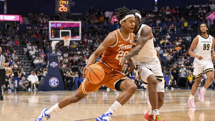 Mar 12, 2025; Nashville, TN, USA;  Texas Longhorns guard Tre Johnson (20) dribbles past Vanderbilt Commodores guard MJ Collins Jr. (2) during the second half at Bridgestone Arena. Mandatory Credit: Steve Roberts-Imagn Images