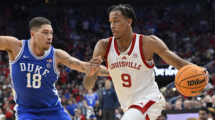 Dec 8, 2024; Louisville, Kentucky, USA;  Louisville Cardinals forward Khani Rooths (9) dribbles against Duke Blue Devils forward Mason Gillis (18) during the second half at KFC Yum! Center. Duke defeated Louisville 76-65. Mandatory Credit: Jamie Rhodes-Imagn Images