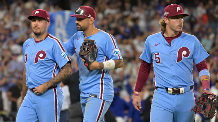 Oct 9, 2025; Los Angeles, California, USA; Philadelphia Phillies relief pitcher Orion Kerkering (50), right fielder Nick Castellanos (8) and second baseman Bryson Stott (5) leave the field after they were defeated by the Los Angeles Dodgers in game four of the NLDS during the 2025 MLB playoffs at Dodger Stadium. Mandatory Credit: Jayne Kamin-Oncea-Imagn Images