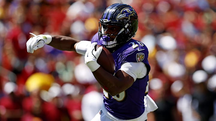 Aug 23, 2025; Landover, Maryland, USA; Baltimore Ravens running back Rasheen Ali (26) runs the ball for a touchdown during the first quarter against the Washington Commanders at Northwest Stadium. Mandatory Credit: Peter Casey-Imagn Images