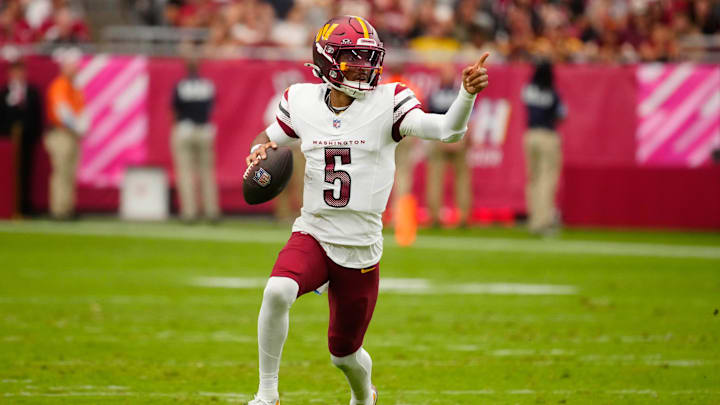Commanders quarterback Jayden Daniels (5) looks for open receivers against the Cardinals during a game at State Farm Stadium in Glendale on Sept. 29, 2024.