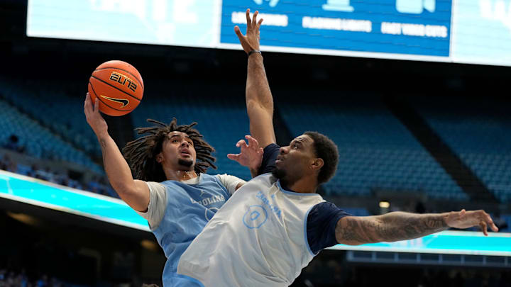 Oct 12, 2024; Chapel Hill, NC, USA;  North Carolina Tar Heels guard Elliot Cadeau (3) shoots as forward Ty Claude (0) defends in the first half at the Dean E. Smith Center. Mandatory Credit: Bob Donnan-Imagn Images