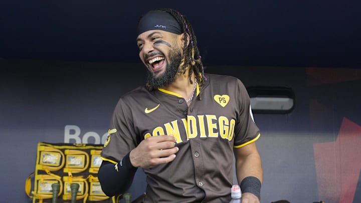 Fernando Tatis Jr. smiles in the dugout before a playoff game against the Dodgers in 2024.