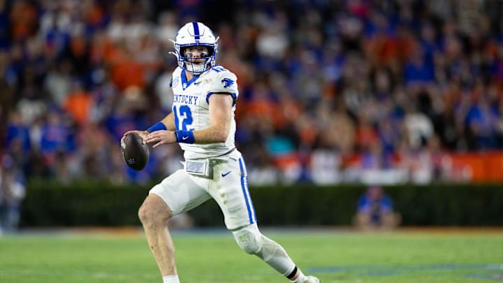 Oct 19, 2024; Gainesville, Florida, USA; Kentucky Wildcats quarterback Brock Vandagriff (12) runs with the ball looking to pass against the Florida Gators during the second half at Ben Hill Griffin Stadium. Mandatory Credit: Matt Pendleton-Imagn Images