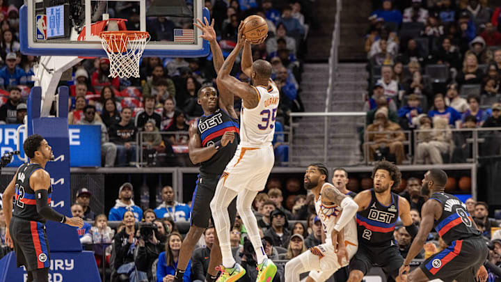 Jan 18, 2025; Detroit, Michigan, USA; Detroit Pistons center Jalen Duren (0) defends against Phoenix Suns forward Kevin Durant (35) during the first quarter at Little Caesars Arena. Mandatory Credit: David Reginek-Imagn Images