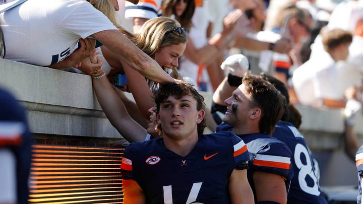 Sep 13, 2025; Charlottesville, Virginia, USA; Virginia Cavaliers quarterback Cole Geer (16) celebrates with fans in the stands after defeating the William & Mary Tribe at Scott Stadium. Mandatory Credit: Amber Searls-Imagn Images Sep 13, 2025; Charlottesville, Virginia, USA; Virginia Cavaliers quarterback Cole Geer (16) celebrates with fans in the stands after defeating the William & Mary Tribe at Scott Stadium. Mandatory Credit: Amber Searls-Imagn Images