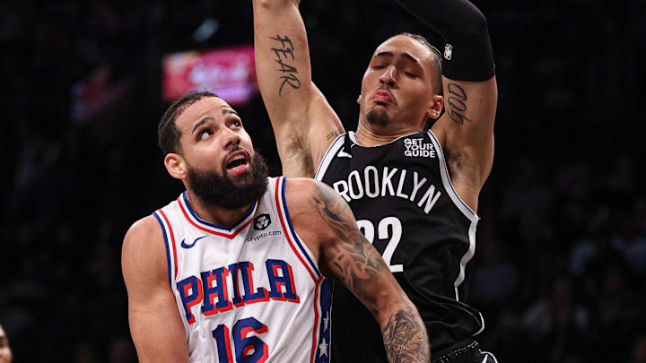 Jan 4, 2025; Brooklyn, New York, USA; Philadelphia 76ers forward Caleb Martin (16) goes to the basket asBrooklyn Nets forward Jalen Wilson (22) defends during the first quarter at Barclays Center. Mandatory Credit: Vincent Carchietta-Imagn Images