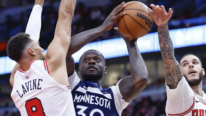 Oct 16, 2024; Chicago, Illinois, USA; Chicago Bulls guard Zach LaVine (8) jumps as guard Lonzo Ball (2) blocks Minnesota Timberwolves forward Julius Randle (30) during the first half at United Center. Mandatory Credit: Kamil Krzaczynski-Imagn Images