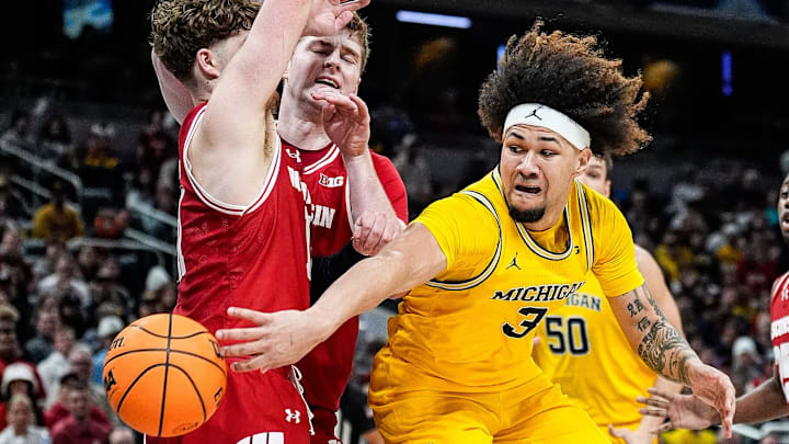 Michigan guard Tre Donaldson (3) makes a pass against Wisconsin guard Max Klesmit (11) during the second half of Big Ten Tournament championship game at Gainbridge Fieldhouse in Indianapolis, Ind. on Sunday, March 16, 2025.