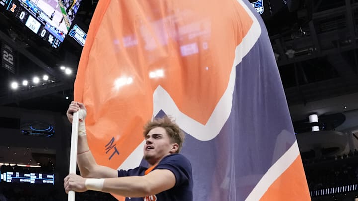 Mar 23, 2025; Milwaukee, WI, USA;  An Illinois Fighting Illini cheerleader performs prior to the game against the Kentucky Wildcats in the second round of the NCAA Tournament at Fiserv Forum. Mandatory Credit: Jeff Hanisch-Imagn Images
