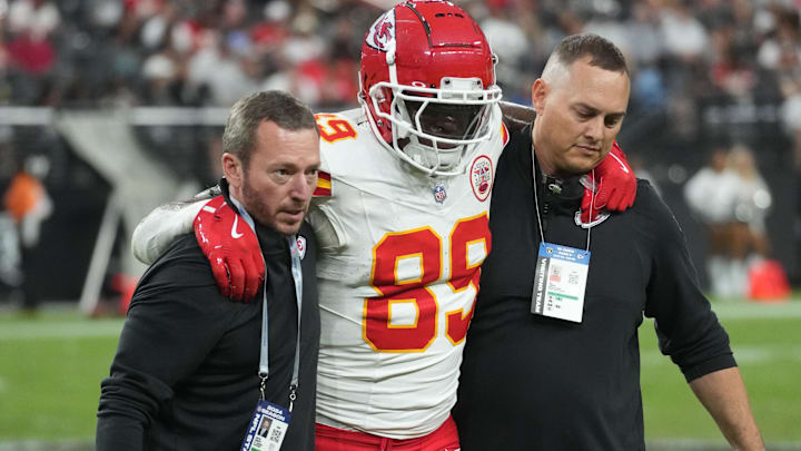 Oct 27, 2024; Paradise, Nevada, USA; Kansas City Chiefs tight end Jody Fortson (89) is assisted off the field after suffering an injury by John Paul Schroeppel (left) and Luke Thompson (right) in the second half against the Las Vegas Raiders at Allegiant Stadium. Mandatory Credit: Kirby Lee-Imagn Images Oct 27, 2024; Paradise, Nevada, USA; Kansas City Chiefs tight end Jody Fortson (89) is assisted off the field after suffering an injury by John Paul Schroeppel (left) and Luke Thompson (right) in the second half against the Las Vegas Raiders at Allegiant Stadium. Mandatory Credit: Kirby Lee-Imagn Images