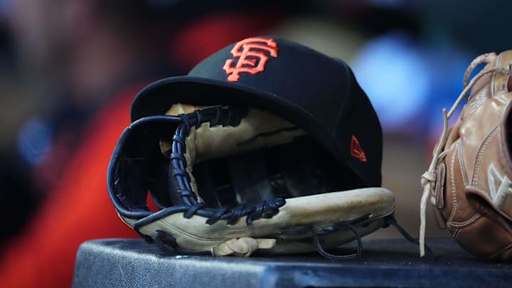 General view of a San Francisco Giants cap and glove during the eighth inning against the Colorado Rockies at Coors Field. 
