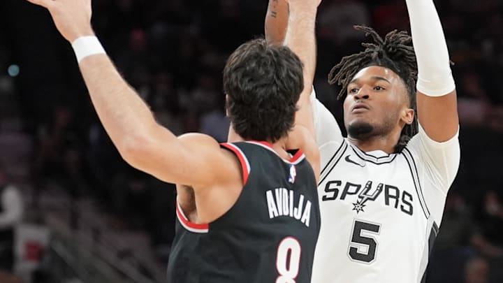 Nov 7, 2024; San Antonio, Texas, USA;  San Antonio Spurs guard Stephon Castle (5) shoots over Portland Trail Blazers forward Deni Avdija (8) in the first half at Frost Bank Center. Mandatory Credit: Daniel Dunn-Imagn Images