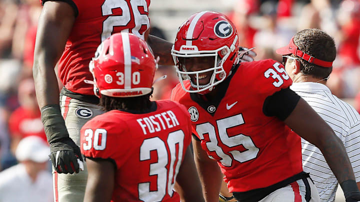 Georgia outside linebacker Damon Wilson Jr. (35) celebrates with Georgia outside linebacker Samuel M'Pemba (26) and Georgia inside linebacker Terrell Foster (30) aft getting a sack during the UGA G-Day spring football game at Sanford Stadium in Athens, Ga., on Saturday, April 15, 2023. Red won 31-26.

News Joshua L Jones