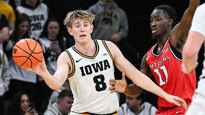 Jan 20, 2026; Iowa City, Iowa, USA; Iowa Hawkeyes forward Cooper Koch (8) controls the ball as Rutgers Scarlet Knights forward Christopher Nwuli (11) defends during the first half at Carver-Hawkeye Arena. Mandatory Credit: Jeffrey Becker-Imagn Images