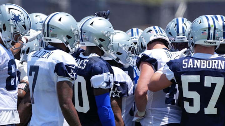 Dallas Cowboys players huddle at training camp at the River Ridge Fields.
