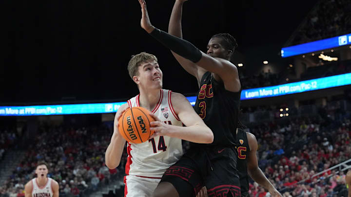 Mar 14, 2024; Las Vegas, NV, USA; Arizona Wildcats center Motiejus Krivas (14) shoots the ball against Southern California Trojans forward Vincent Iwuchukwu (3) in the first half at T-Mobile Arena. Mandatory Credit: Kirby Lee-Imagn Images Mar 14, 2024; Las Vegas, NV, USA; Arizona Wildcats center Motiejus Krivas (14) shoots the ball against Southern California Trojans forward Vincent Iwuchukwu (3) in the first half at T-Mobile Arena. Mandatory Credit: Kirby Lee-Imagn Images