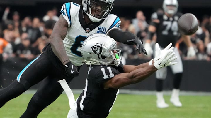 Sep 22, 2024; Paradise, Nevada, USA; Las Vegas Raiders wide receiver Tre Tucker (11) attempts to catch the ball against Carolina Panthers cornerback Jaycee Horn (8) in the second half at Allegiant Stadium. Mandatory Credit: Kirby Lee-Imagn Images