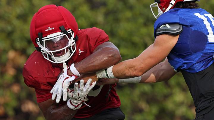 Oklahoma quarterback John Mateer, right, hands the ball offl to Jonathan Hatton Jr. during football practice for the OU Sooners at the stadium practice fields in Norman, Okla., Friday, August 7, 2026. Oklahoma quarterback John Mateer, right, hands the ball offl to Jonathan Hatton Jr. during football practice for the OU Sooners at the stadium practice fields in Norman, Okla., Friday, August 7, 2026.