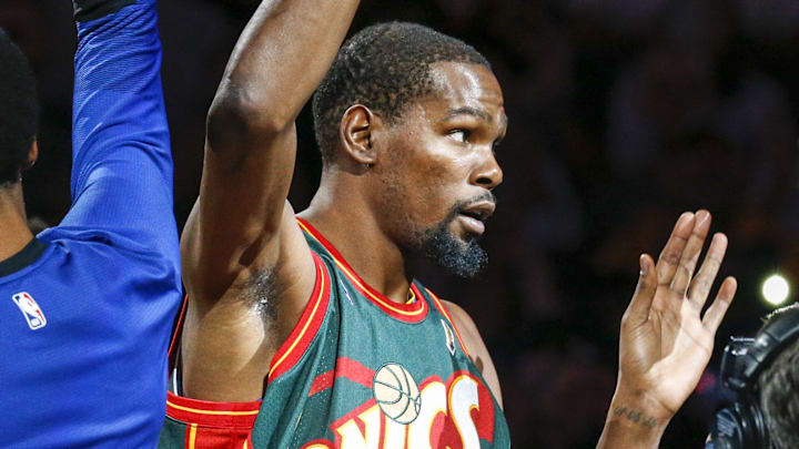 Oct. 5, 2018; Seattle, WA, USA; Golden State Warriors forward Kevin Durant (35) is introduced prior to tipoff against the Sacramento Kings while wearing a Seattle Supersonics Shawn Kemp jersey at KeyArena.