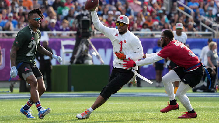 Feb 2, 2025; Orlando, FL, USA; AFC wide receiver Ja'Marr Chase of the Cincinnati Bengals (1) carries the ball against NFC strong safety Budda Baker of the Arizona Cardinals (3)during the 2025 Pro Bowl Games at Camping World Stadium. Mandatory Credit: Kirby Lee-Imagn Images Feb 2, 2025; Orlando, FL, USA; AFC wide receiver Ja'Marr Chase of the Cincinnati Bengals (1) carries the ball against NFC strong safety Budda Baker of the Arizona Cardinals (3)during the 2025 Pro Bowl Games at Camping World Stadium. Mandatory Credit: Kirby Lee-Imagn Images