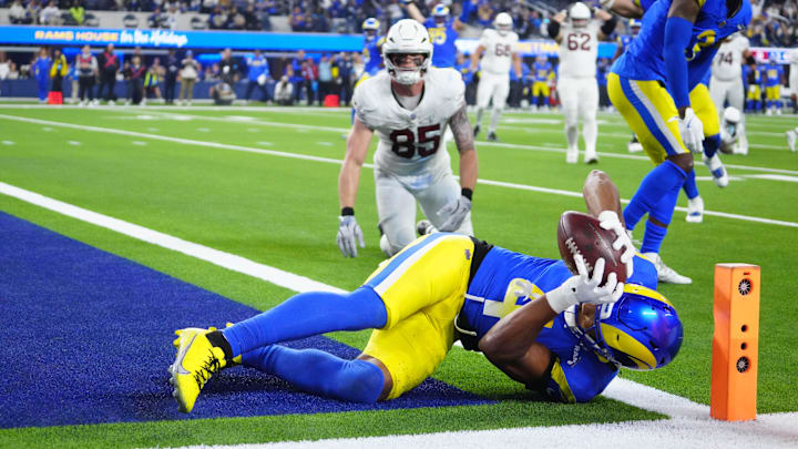 Dec 28, 2024; Inglewood, California, USA; Los Angeles Rams cornerback Ahkello Witherspoon (4) intercepts a pass with 42 seconds left against the Arizona Cardinals at SoFi Stadium. Mandatory Credit: Kirby Lee-Imagn Images