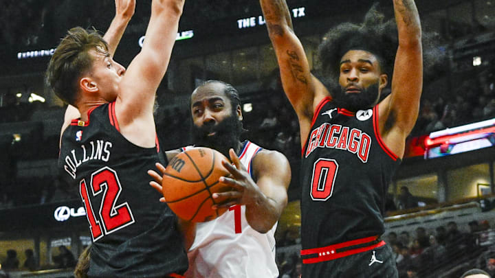 Feb 26, 2025; Chicago, Illinois, USA;  LA Clippers guard James Harden (1) passes the ball between Chicago Bulls forward Zach Collins (12) and guard Coby White (0) during the first half  at the United Center. Mandatory Credit: Matt Marton-Imagn Images