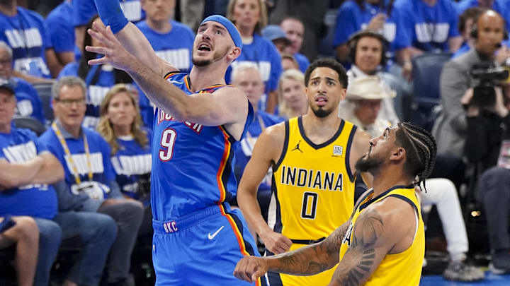 Jun 8, 2025; Oklahoma City, Oklahoma, USA; Oklahoma City Thunder guard Alex Caruso (9) drives to the basket past Indiana Pacers guard Tyrese Haliburton (0) during the fourth quarter of game two of the 2025 NBA Finals at Paycom Center. Mandatory Credit: Kyle Terada-Imagn Images