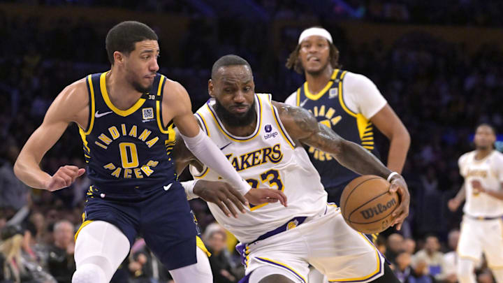Mar 24, 2024; Los Angeles, California, USA;   Los Angeles Lakers forward LeBron James (23) drives past Indiana Pacers guard Tyrese Haliburton (0) in the second half at Crypto.com Arena. Mandatory Credit: Jayne Kamin-Oncea-Imagn Images