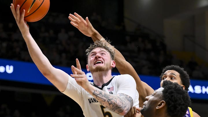 Jan 10, 2026; Nashville, Tennessee, USA; Vanderbilt Commodores forward Tyler Nickel (5) lays the ball in over Louisiana State Tigers forward Pablo Tamba (8) during the second half at Memorial Gymnasium. Mandatory Credit: Steve Roberts-Imagn Images