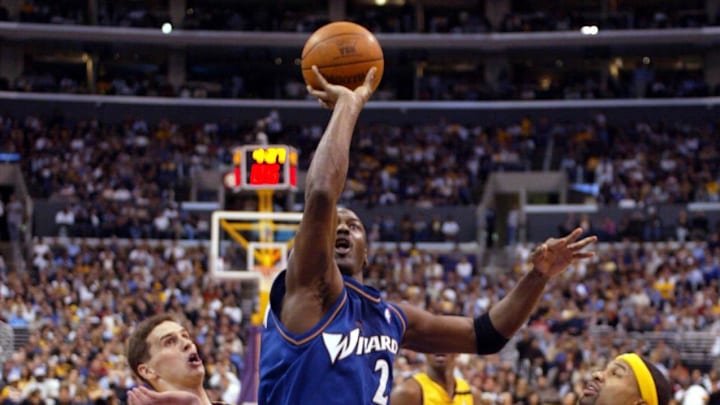 Mar 28, 2003; Los Angeles, CA, USA; FILE PHOTO;  Washington Wizards guard Michael Jordan (23) slices between Los Angeles Lakers forward Mark Madsen (35) and Derek Fisher (2) and Rick Fox (44) as he goes to the basket during the Wizards  108 - 94 loss to the Lakers at Staples Center. Jordan scored 23 points in the game.  Mandatory Credit: Robert Hanashiro-Imagn Images