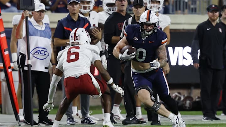 Sep 20, 2025; Charlottesville, Virginia, USA; Virginia Cavaliers tight end Sage Ennis (0) runs with the ball after making a catch as Stanford Cardinal cornerback Collin Wright (6) defends during the first quarter at Scott Stadium. Mandatory Credit: Geoff Burke-Imagn Images