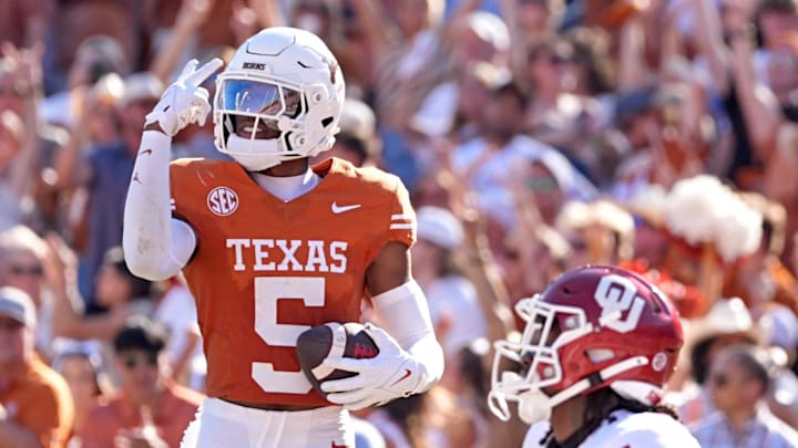 Texas Longhorns defensive back Malik Muhammad (5) celebrates an interception intended for Oklahoma Sooners wide receiver Deion Burks (4) in the first half of the Red River Rivalry college football game between the University of Oklahoma Sooners and the Texas Longhorn at the Cotton Bowl Stadium in Dallas, Texas, Saturday, Oct. 11, 2025.