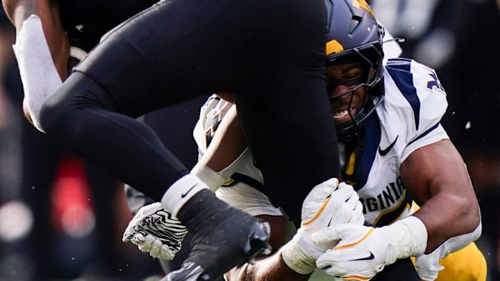 West Virginia Mountaineers linebacker Josiah Trotter (40) tackles Cincinnati Bearcats running back Evan Pryor (6) in the fourth quarter of a college football game between the Cincinnati Bearcats and West Virginia Mountaineers, Saturday, Nov. 9, 2024, at Nippert Stadium in Cincinnati. Mountaineers won 31-24.