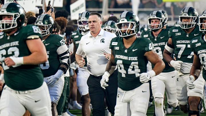 Michigan State’s head coach Pat Fitzgerald, center, runs onto the field with the team before the game against Toledo on Friday, Sept. 4, 2026, at Spartan Stadium in East Lansing. Michigan State’s head coach Pat Fitzgerald, center, runs onto the field with the team before the game against Toledo on Friday, Sept. 4, 2026, at Spartan Stadium in East Lansing.
