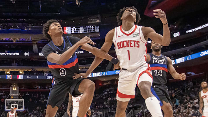 Jan 12, 2024; Detroit, Michigan, USA; Detroit Pistons forward Ausar Thompson (9) battles for for the ball with his twin brother Houston Rockets forward Amen Thompson (1) during the first half at Little Caesars Arena. Mandatory Credit: David Reginek-Imagn Images