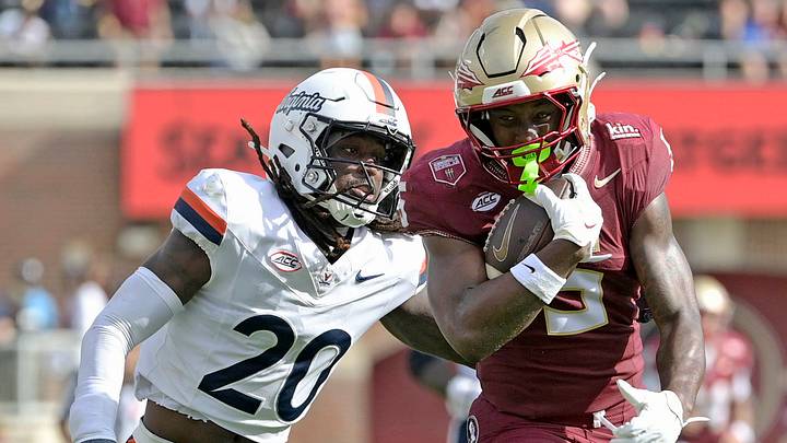 Oct 3, 2026; Tallahassee, Florida, USA; Florida State Seminoles running back Quintrevion Wisner (5) runs past Virginia Cavaliers defensive back Omillio Agard (20) during the second half at Doak S. Campbell Stadium. Mandatory Credit: Melina Myers-Imagn Images Oct 3, 2026; Tallahassee, Florida, USA; Florida State Seminoles running back Quintrevion Wisner (5) runs past Virginia Cavaliers defensive back Omillio Agard (20) during the second half at Doak S. Campbell Stadium. Mandatory Credit: Melina Myers-Imagn Images
