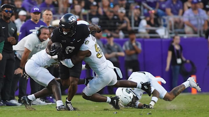 Oct 4, 2025; Fort Worth, Texas, USA; TCU Horned Frogs running back Trent Battle (6) is tackled by Colorado Buffaloes defensive back Teon Parks (3) and linebacker Reginald Hughes (50) during the first half at Amon G. Carter Stadium. Mandatory Credit: Raymond Carlin III-Imagn Images