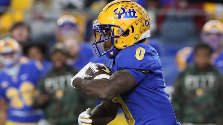 Nov 9, 2024; Pittsburgh, Pennsylvania, USA;  Pittsburgh Panthers running back Desmond Reid (0) carries the ball against the Virginia Cavaliers during the third quarter at Acrisure Stadium. Mandatory Credit: Charles LeClaire-Imagn Images