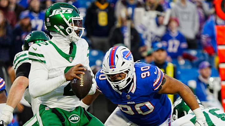 Buffalo Bills defensive tackle DeWayne Carter (90) heads towards New York Jets quarterback Tyrod Taylor (2) during second half action at the Bills home game against the New York Jets at Highmark Stadium in Orchard Park on Dec. 29, 2024.