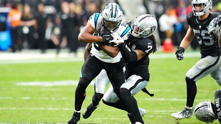 Sep 22, 2024; Paradise, Nevada, USA; Carolina Panthers running back Chuba Hubbard (30) attempts to break the tackle of Las Vegas Raiders safety Tre'von Moehrig (7) during the third quarter at Allegiant Stadium. 