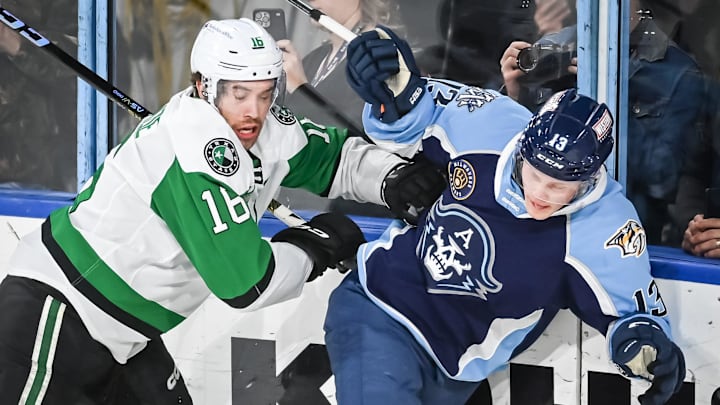 Texas Stars left wing Curtis McKenzie (16) and Milwaukee Admirals center Juuso Parssinen (13) crash into the glass during the second period of their game Saturday, February 10, 2024, at the UW-Milwaukee Panther Arena in Milwaukee, Wisconsin.