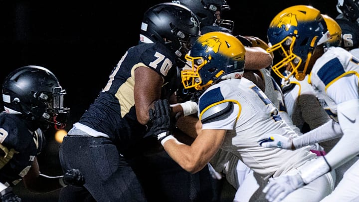 The Truman High School and Cheltenham lines collide during a football game in Levittown on Friday, Oct. 18, 2024.