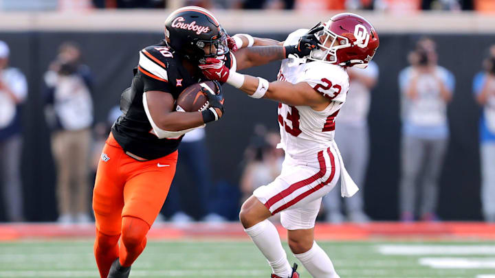 Oklahoma State's Rashod Owens (10) stiff arms Oklahoma's Jasiah Wagoner (23) during a Bedlam college football game between the Oklahoma State University Cowboys (OSU) and the University of Oklahoma Sooners (OU) at Boone Pickens Stadium in Stillwater, Okla., Saturday, Nov. 4, 2023.
